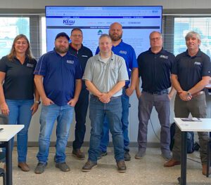 KTSU America sales rep, JW Bass standing with the Road Builders team after delivering a tutorial on navigating KTSU online ordering and parts navigation.